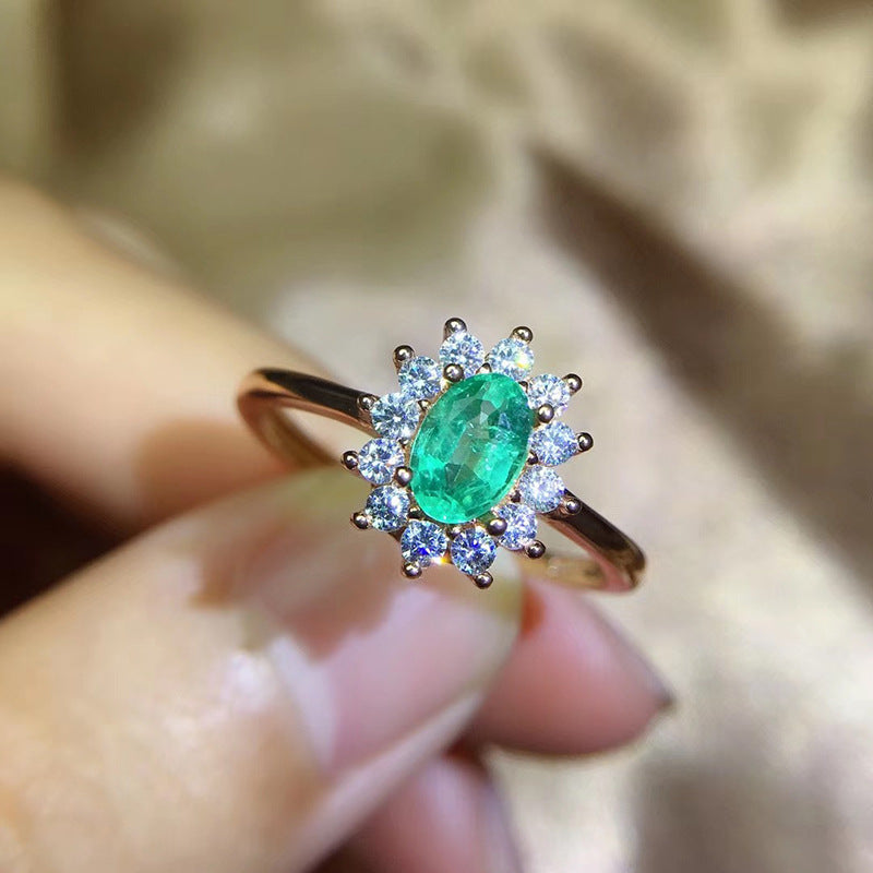 Emerald Oval Cut Engagement Ring in Sterling Silver with Halo Design