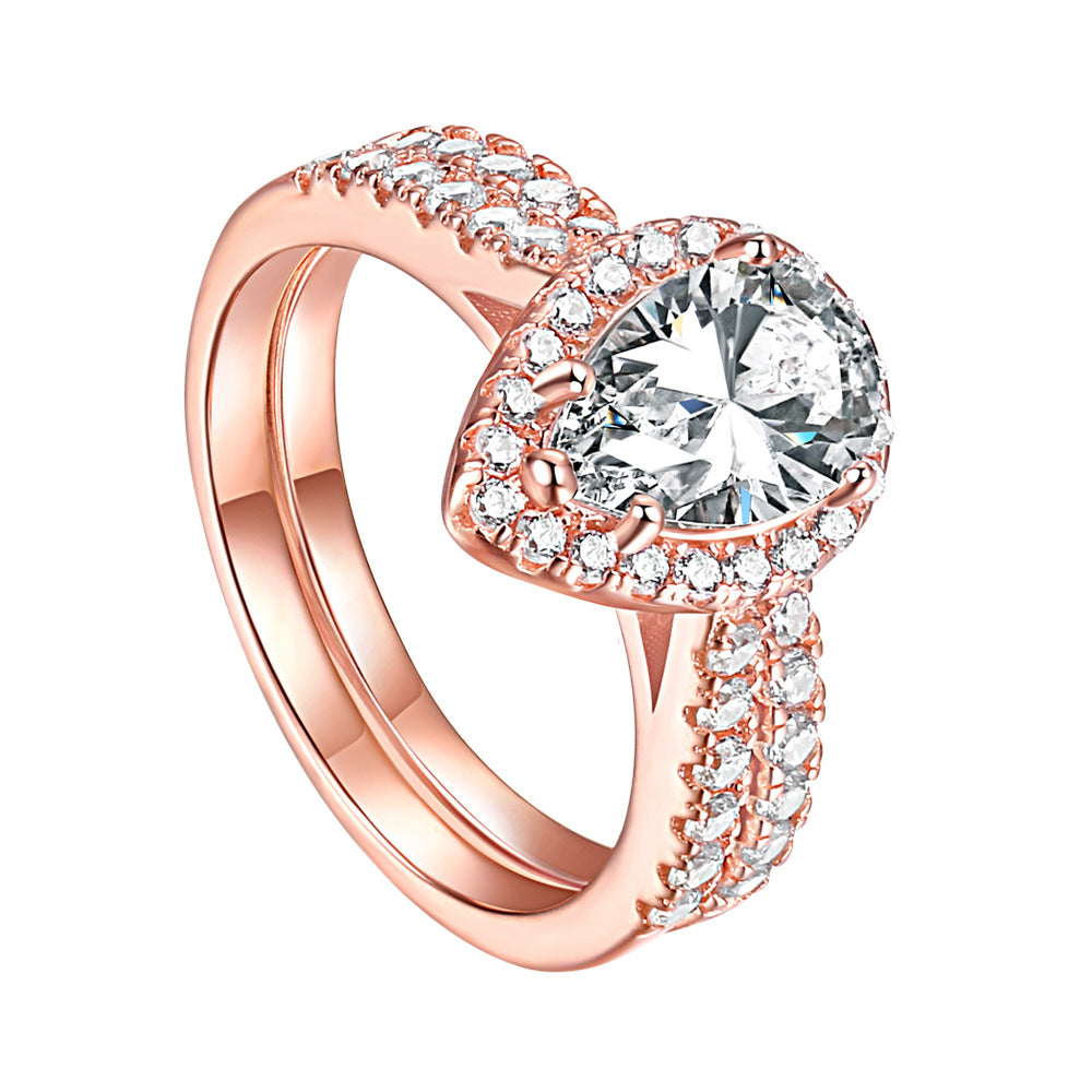 1.5-Carat Pear Cut Simulated Colorless Diamond Wedding Set in White Gold & Rose Gold-Plated Sterling Silver with Halo Design