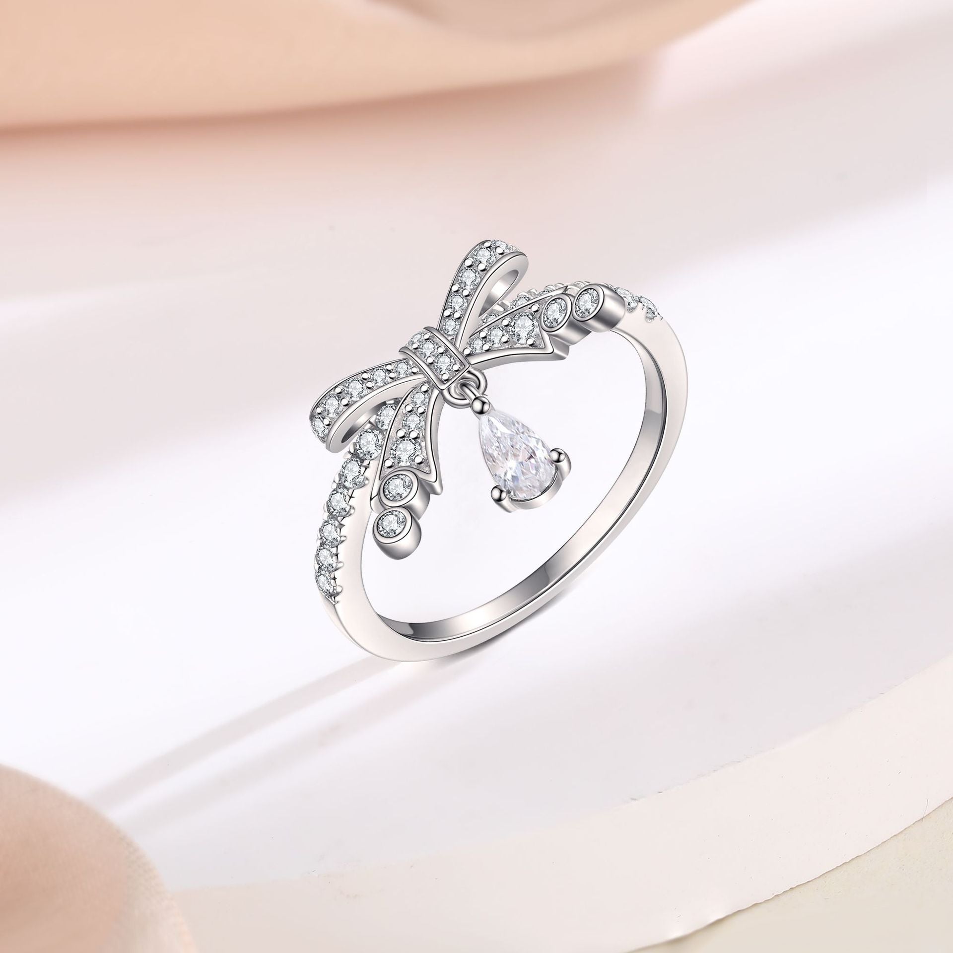 Pear Cut Simulated Colorless Diamond Bow Design Engagement Ring