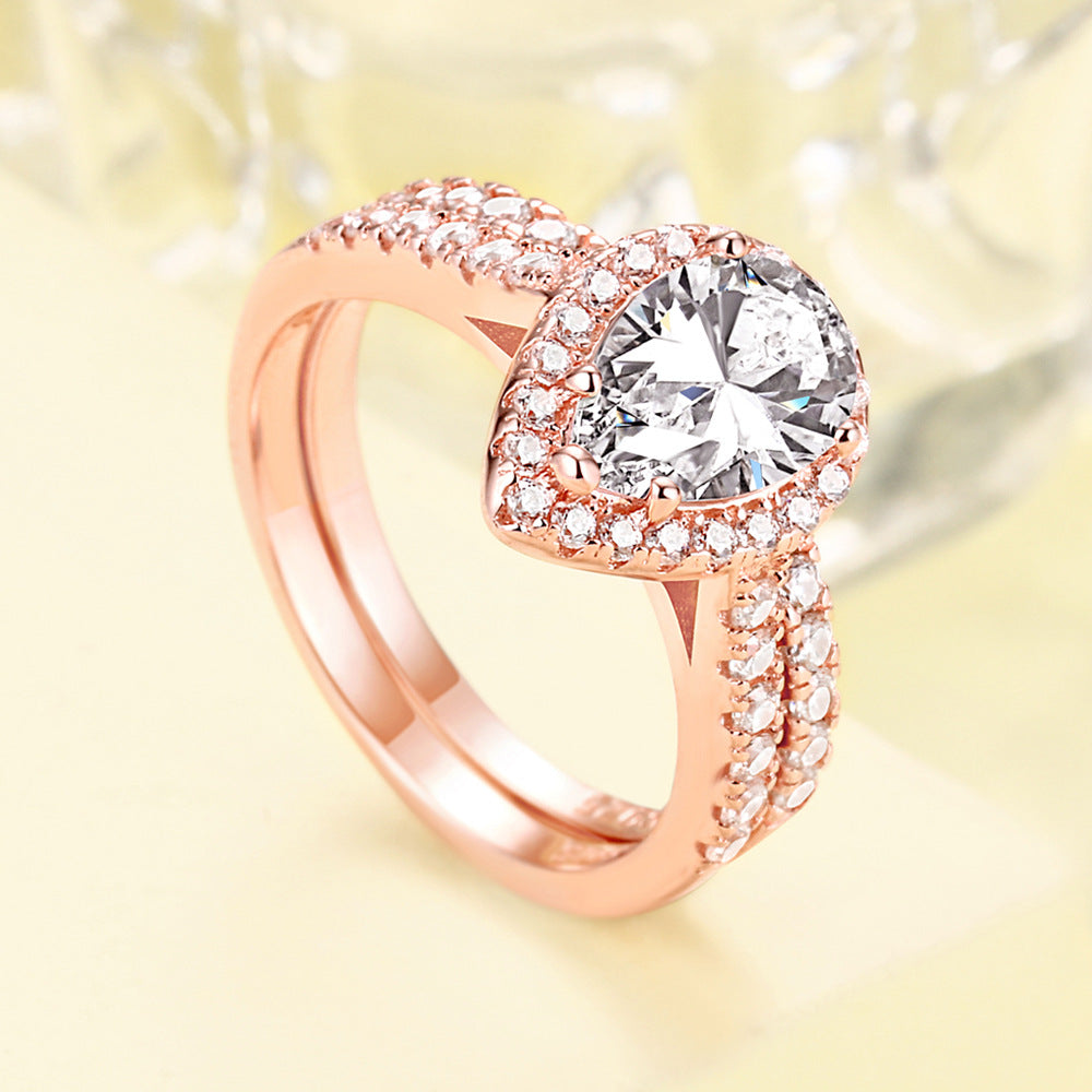 1.5-Carat Pear Cut Simulated Colorless Diamond Wedding Set in White Gold & Rose Gold-Plated Sterling Silver with Halo Design