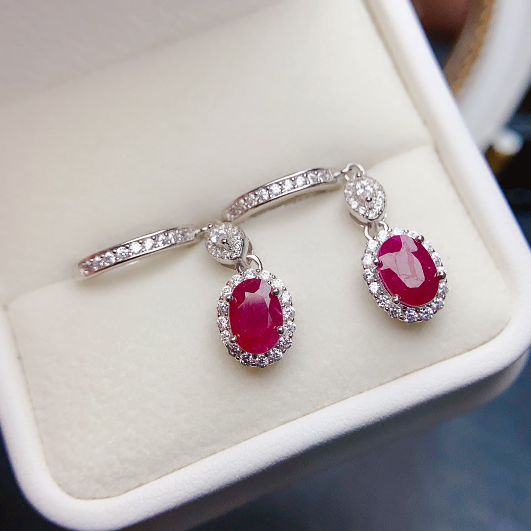 Ruby Oval Cut Drop Earrings in Sterling Silver with Halo Design